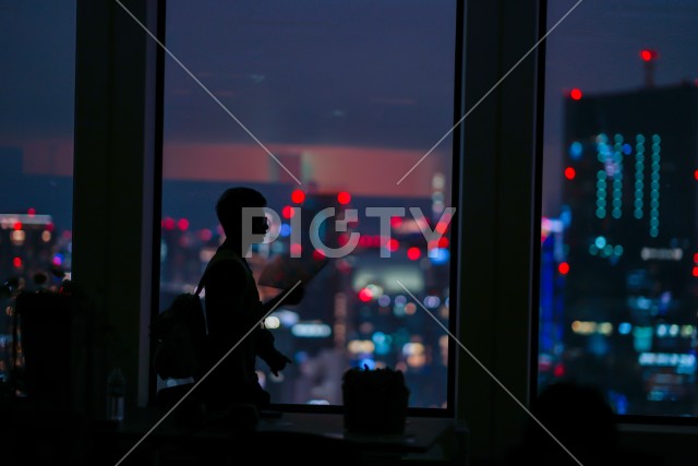 都会の夜景と人々のシルエット