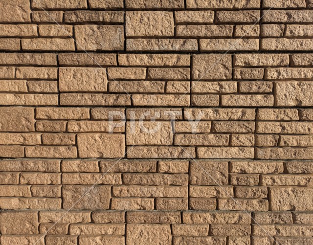 不規則な石積み風デザインのモダンなベージュの外壁タイルテクスチャ